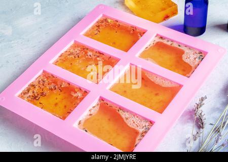 Handmade soap in a mold. Natural organic diy cosmetics with lavender Stock Photo