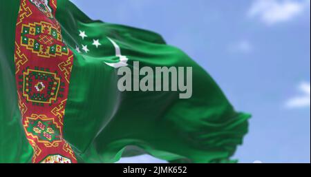 Detail of the national flag of Turkmenistan waving in the wind on a clear day Stock Photo