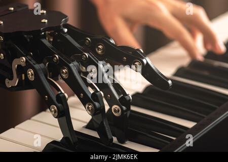 Human with neural hand prosthesis playing piano Stock Photo