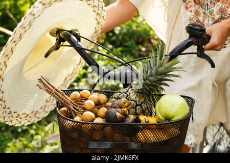 Basket on the bicycle full of different exotic fruits Stock Photo