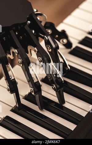 Human with neural hand prosthesis playing piano Stock Photo