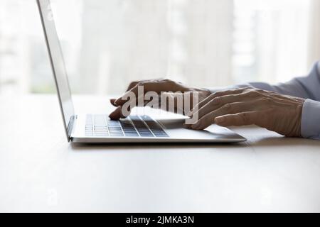 Middle aged adult employee, business professional typing on laptop Stock Photo