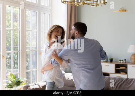 Untroubled couple in love dance together at modern home Stock Photo