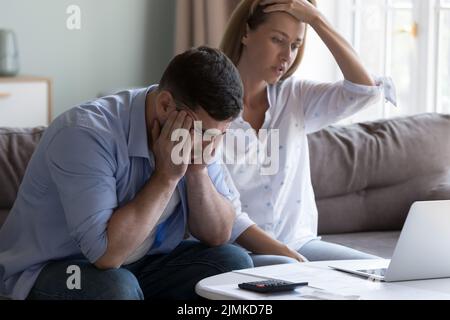 Spouses manage finances, analyze expenses, check budget looks disappointed Stock Photo