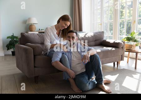Couple in love relaxing in sunny cozy living room Stock Photo