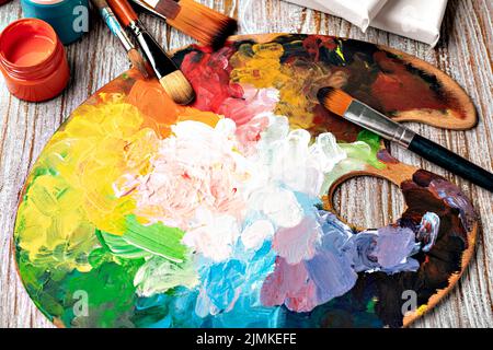 Art palette with colorful mixed paints Stock Photo