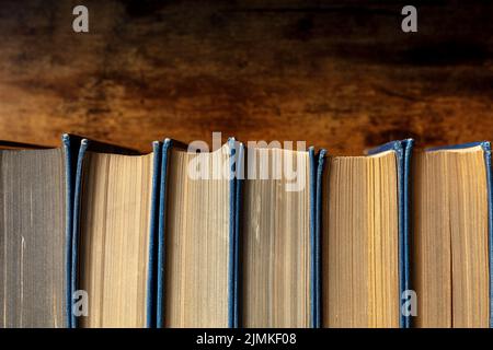 Old books on a shelf, overhead shot. Classic literature in a bookshop Stock Photo