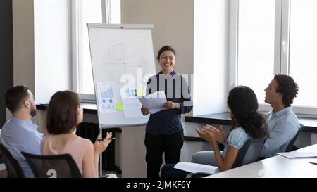 Multiethnic staff applauding to Indian businesslady trainer accomplish seminar Stock Photo