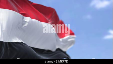 Detail of the national flag of Yemen waving in the wind on a clear day Stock Photo