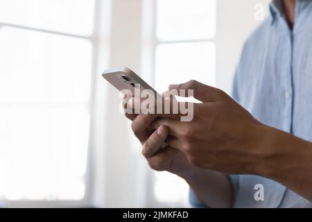 Male hands using modern smart phone, close up cropped shot Stock Photo