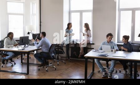 Multi ethnic company employees working together in modern coworking Stock Photo