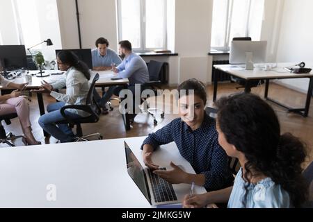 Multi racial company employees working together in co-working Stock Photo