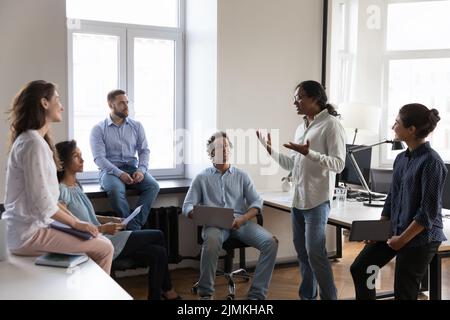 Indian business trainer makes speech during briefing in coworking office Stock Photo
