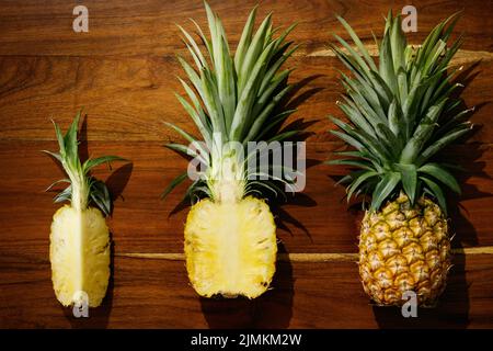 Flat lay of pineapple fruit on wooden surface Stock Photo
