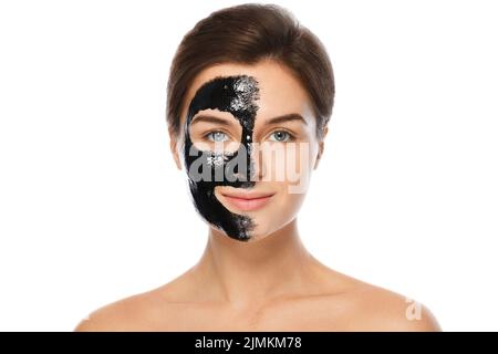 Beautiful woman with a black purifying mask on her face Stock Photo