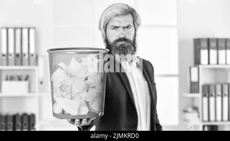 man read piece of paper. office worker digging in garbage bin. businessman hold trashcan. man in office look for lost note in paper bin. crumpled Stock Photo