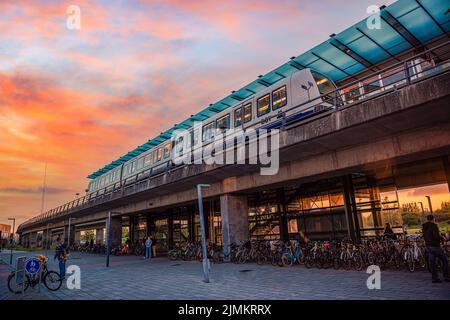 Subway metro train stands at the  rapid transit station of M1 line DR Byen against sunset. Copenhagen, Denmark Stock Photo