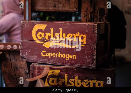Old wooden crates of Carlsberg beer stand in a bar in Copenhagen, Denmark Stock Photo