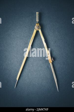 Old vintage pair of compasses on dark background Stock Photo