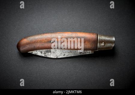 Traditional wooden pocket knife on black background Stock Photo