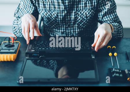 repair shop hardware maintenance technician laptop Stock Photo
