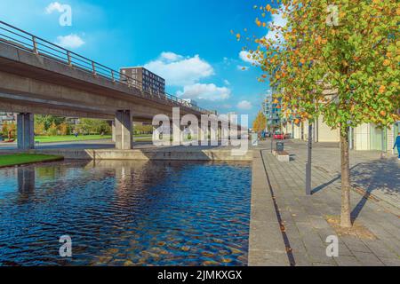 Water canal, metro line and pedestrian street near Ã˜restad boulevard in Copenhagen, Denmark Stock Photo