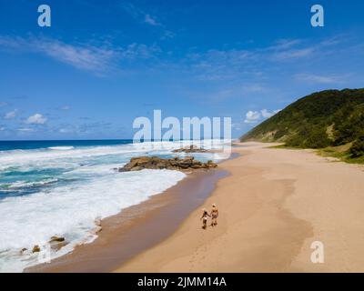 St Lucia South Africa, Rocks sand ocean, and blue coastal skyline at Mission Rocks beach near Cape Vidal in Isimangaliso Wetland Stock Photo