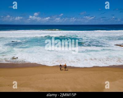 St Lucia South Africa, Rocks sand ocean, and blue coastal skyline at Mission Rocks beach near Cape Vidal in Isimangaliso Wetland Stock Photo