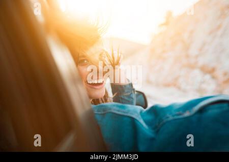 Woman smiling while being car ride Stock Photo
