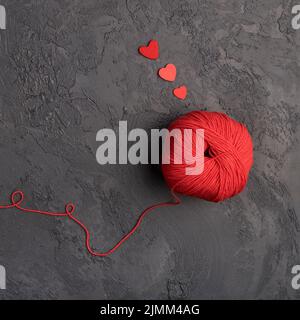 Red wool ball slate background Stock Photo