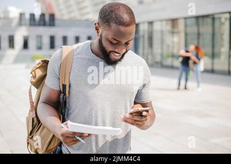 Cheerful student using phone Stock Photo