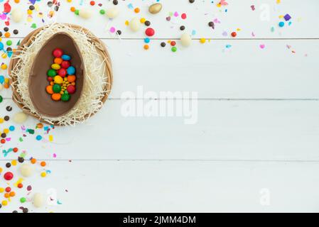 Small candies open easter chocolate egg table Stock Photo