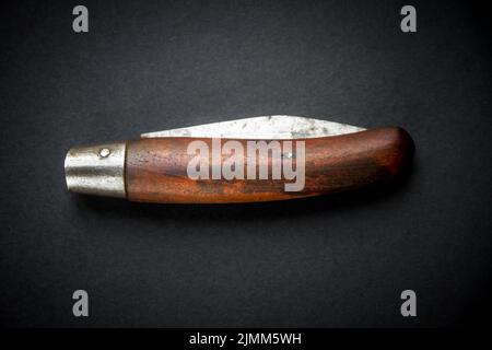 Traditional wooden pocket knife on black background Stock Photo