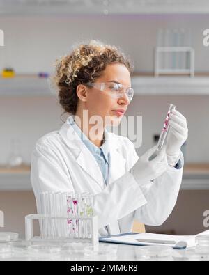Female researcher laboratory with test tubes safety glasses Stock Photo