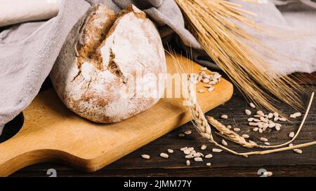 Loaf bread ear wheat dark wooden background Stock Photo