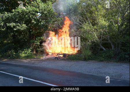 A wildfire by the side of the road in Ardingly, West Sussex during the drought condition's of the summer on the 07th August 2022 Stock Photo