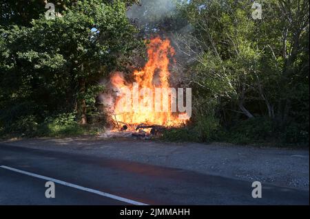 A wildfire by the side of the road in Ardingly, West Sussex during the drought condition's of the summer on the 07th August 2022 Stock Photo