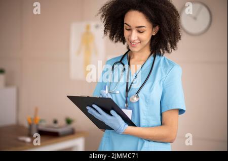 Female doctor taking notes clipboard Stock Photo