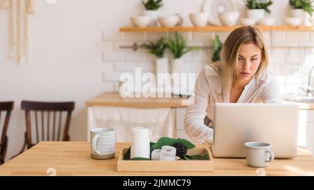 Medium shot woman working from home Stock Photo