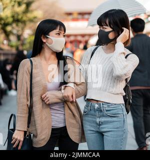 Pretty asian girls wearing face masks Stock Photo