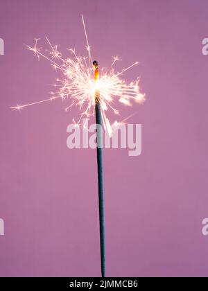 Lighting sparkler pink background Stock Photo