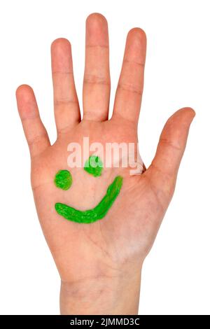 Green smiling face drawn on child palm Stock Photo