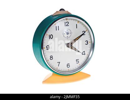 Old metal alarm clock on a white background. Stock Photo