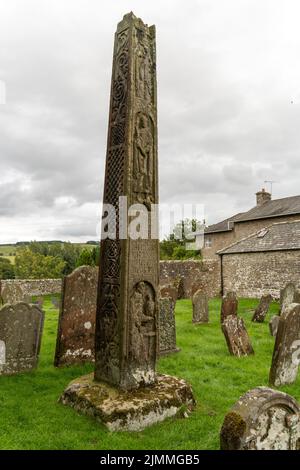 The Bewcastle Cross - Anglo Saxon with runic carving, interlace knots, 7th or 8th century, in St Cuthbert's churchyard, Bewcastle, Cumbria, UK. Stock Photo