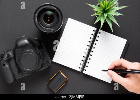 Flat lay camera lenses notebook black background Stock Photo
