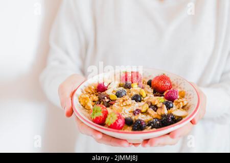 Crop person holding bowl oatmeal Stock Photo