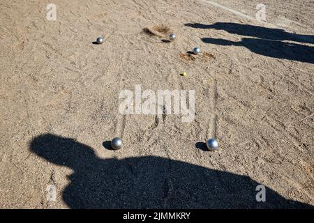 07 August 2022, Schleswig-Holstein, Lübeck: Boule balls lie in the sand at the Holstentorturnier. The Holstentorturnier is considered the largest German boules tournament. Photo: Georg Wendt/dpa Stock Photo