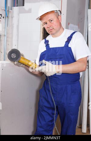 Contractor using angle grinder Stock Photo