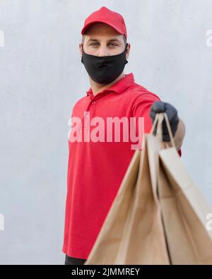 Front view delivery man with package Stock Photo