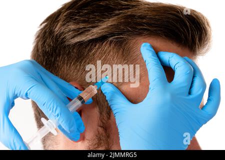 Man receiving scalp injection for hair grow Stock Photo
